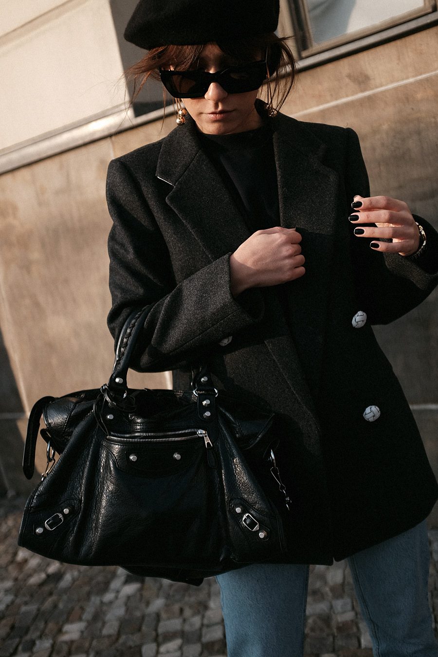 Nisi is wearing: Balenciaga Giant 12 City Bag, Céline Kate Sunglasses, Wool beret, Wrap coat, Mom jeans, Wool blazer, Sweater, Acne Studios Jensen Boots
