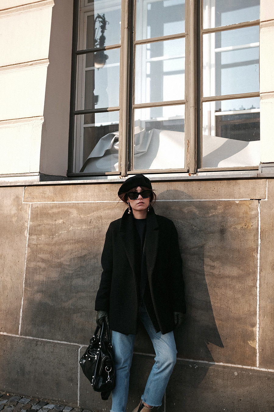 Nisi is wearing: Balenciaga Giant 12 City Bag, Céline Kate Sunglasses, Wool beret, Wrap coat, Mom jeans, Wool blazer, Sweater, Acne Studios Jensen Boots