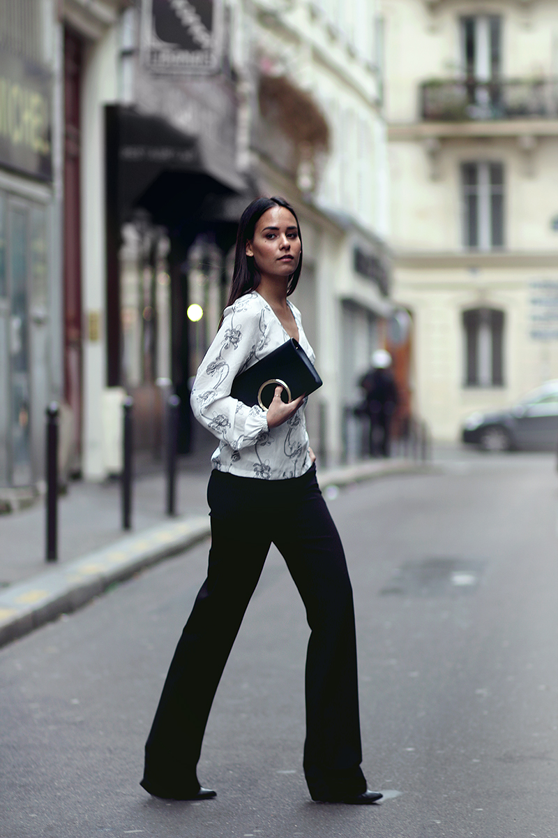 Nisi is wearing: Rodebjer floral wrap top, Chloé Gabrielle Clutch, Warehouse wide leg trousers