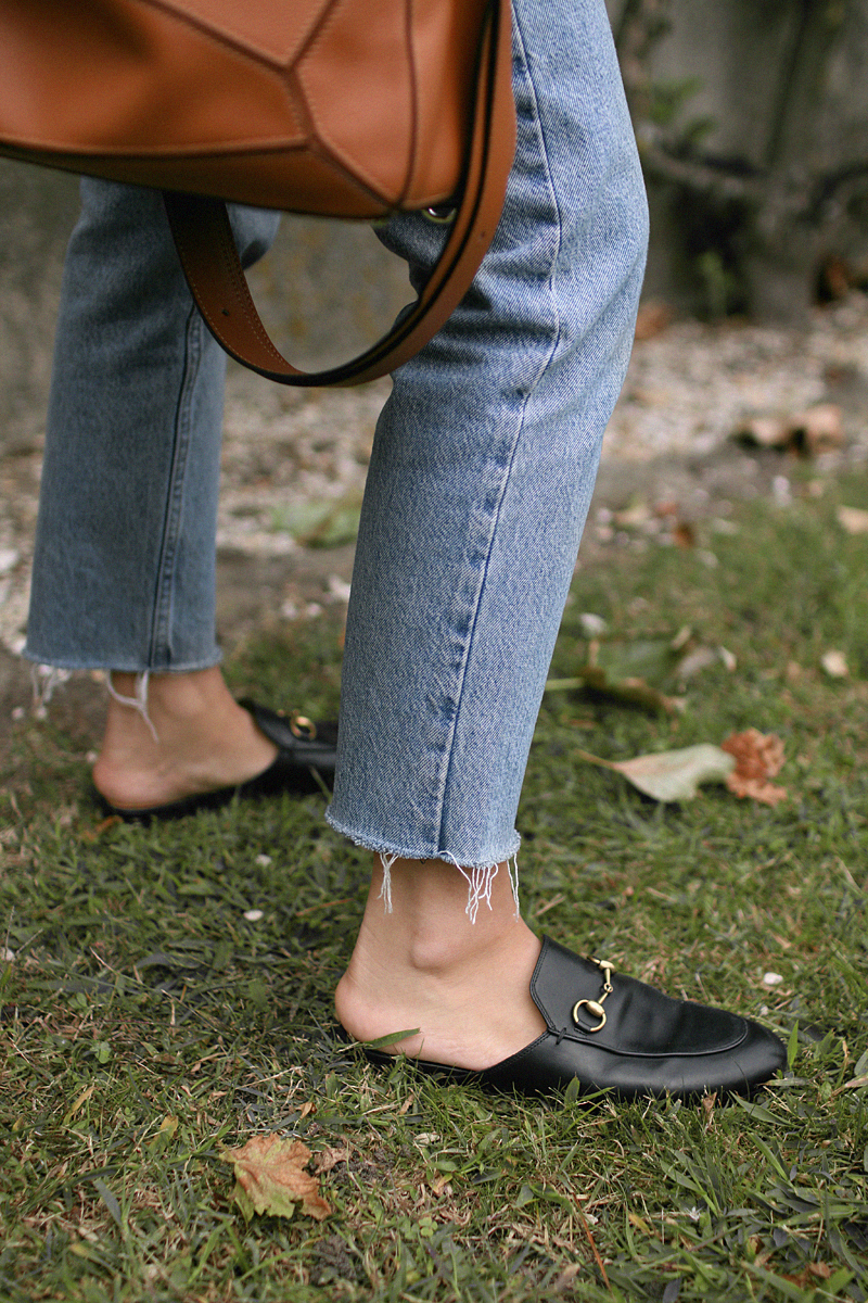 Nisi is wearing: Gingham pattern blouse, Gucci Princetown Slipper, Loewe Puzzle bag, mom jeans
