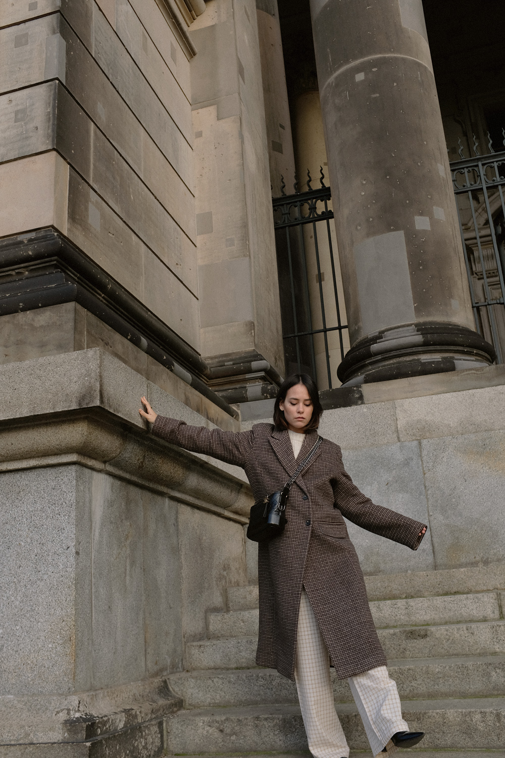Nisi is wearing: Checkered coat LEVETE ROOM. Checkered trousers RÉSUMÉ. Embossed ankle boots ZIGN. Gabrielle bag CHANEL