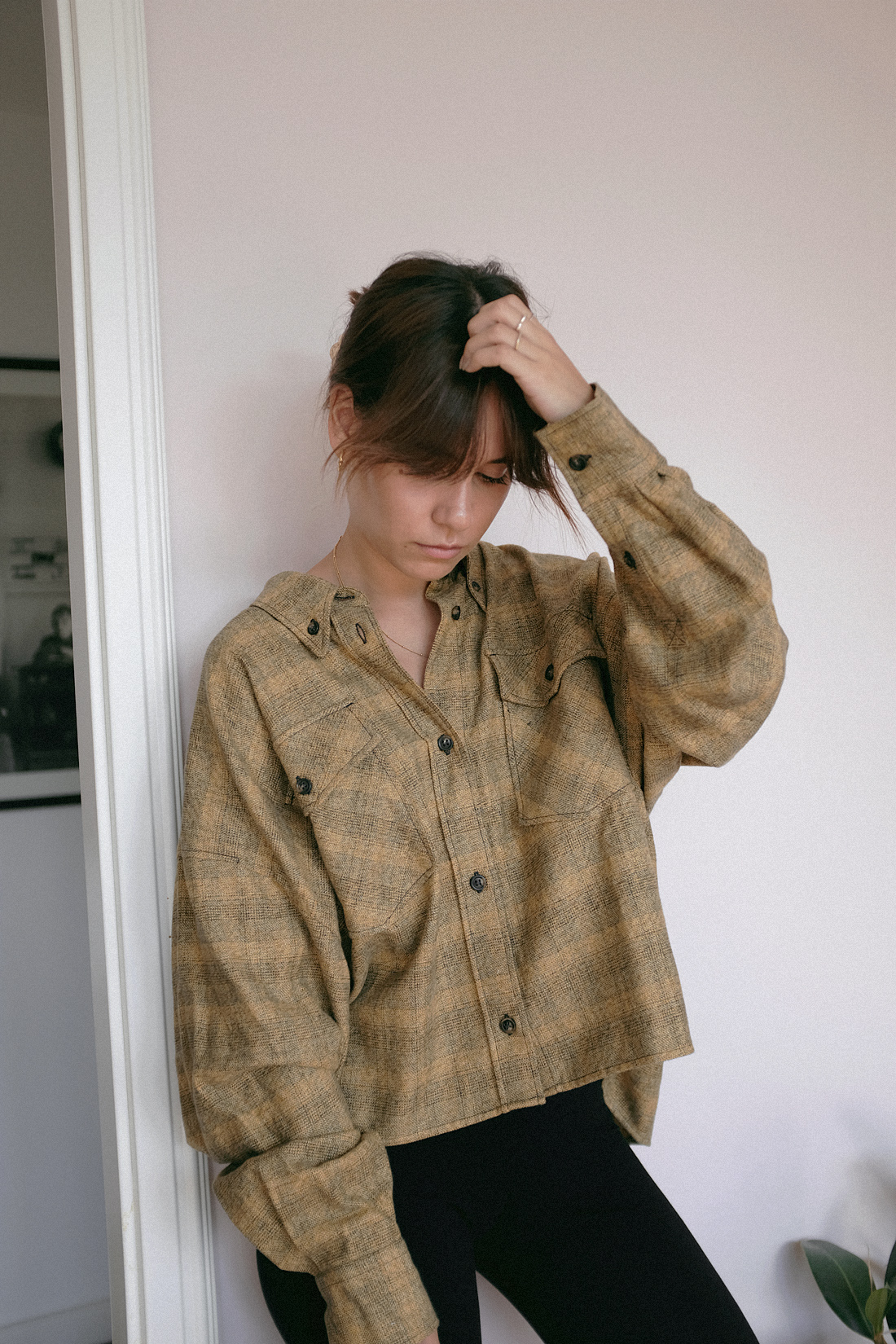 Nisi is wearing: Isabel Marant Etoile delora checked cotton shirt, cycling shorts, The Row Ascot bag, Alighieri jewelry, strappy sandals, crystal hair clip