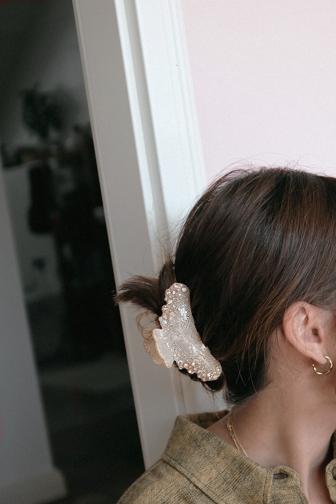 Nisi is wearing: Isabel Marant Etoile delora checked cotton shirt, cycling shorts, The Row Ascot bag, Alighieri jewelry, strappy sandals, crystal hair clip