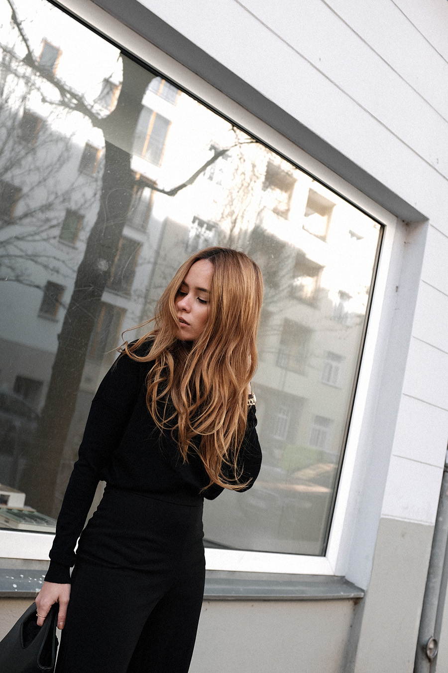 Outfit: All Black. Desi is wearing: Bucket bag, Wool turtleneck, toe mules, wide pants