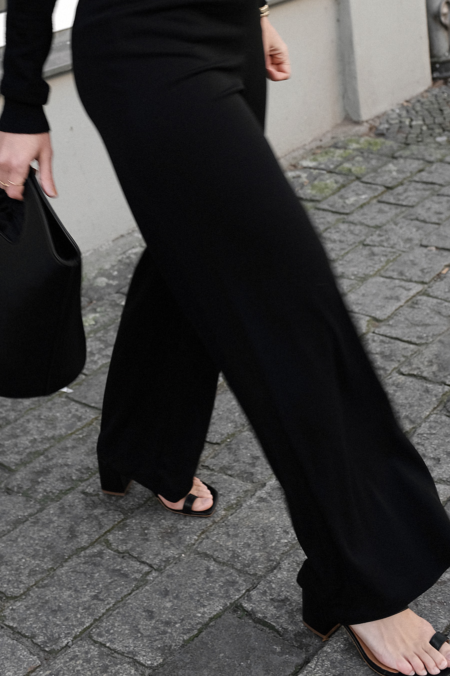 Outfit: All Black. Desi is wearing: Bucket bag, Wool turtleneck, toe mules, wide pants