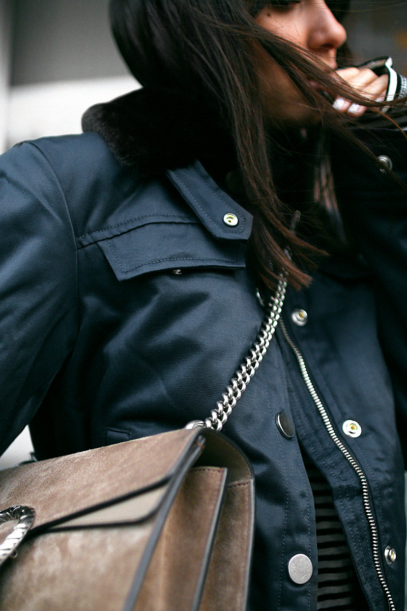 Nisi is wearing: Gucci Dionysus bag, Aviator jacket, Striped top, Flared denim jeans