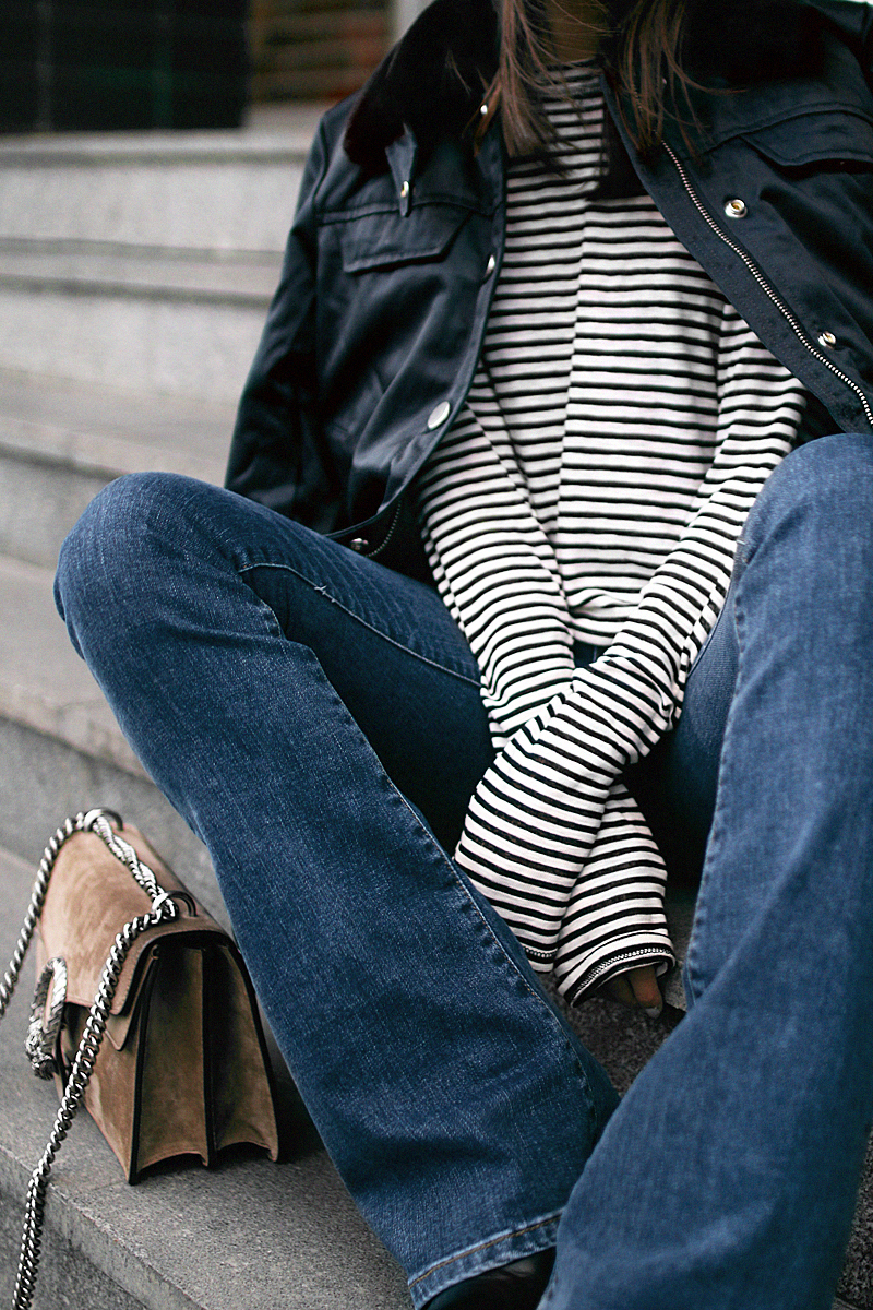Nisi is wearing: Gucci Dionysus bag, Aviator jacket, Striped top, Flared denim jeans