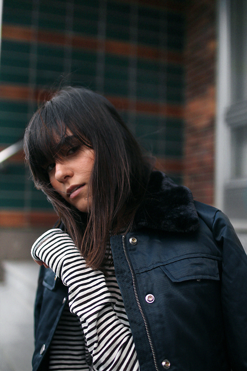 Nisi is wearing: Gucci Dionysus bag, Aviator jacket, Striped top, Flared denim jeans