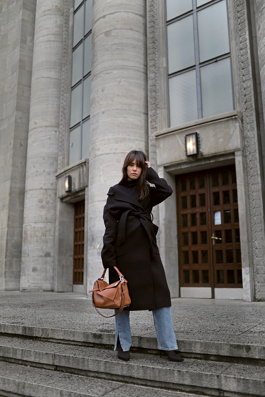 Outfit: Wrap coat and long straight denim. Nisi is wearing: Belted wrap coat, Navy Turtleneck, straight denim jeans, Sock boots, Loewe Puzzle bag