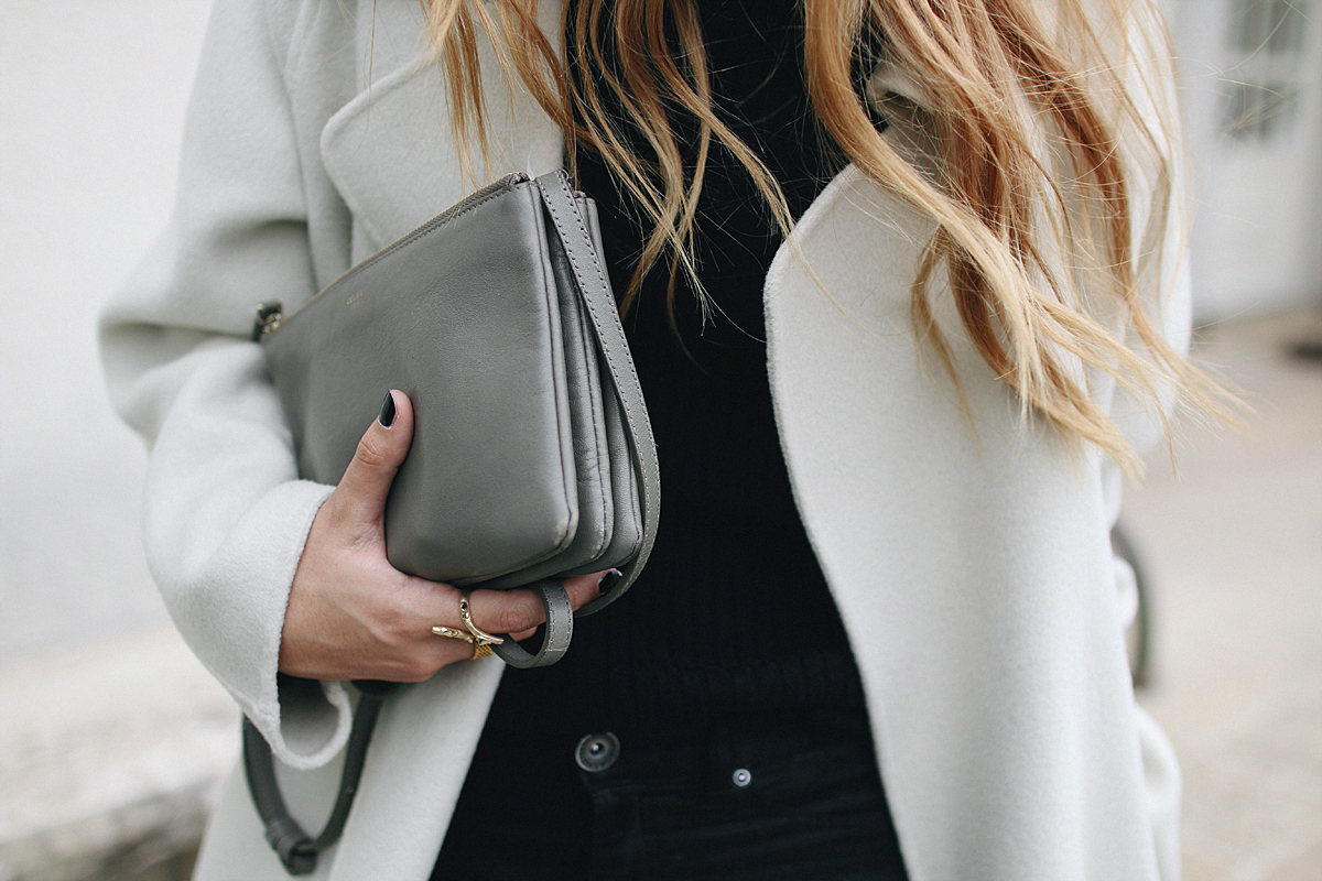 Desi is wearing a Sandro coat, Céline Trio bag, Gucci Princetown slippers and a all black look. - teetharejade.com