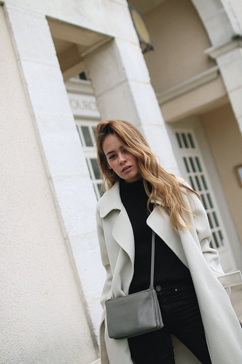 Desi is wearing a Sandro coat, Céline Trio bag, Gucci Princetown slippers and a all black look. - teetharejade.com