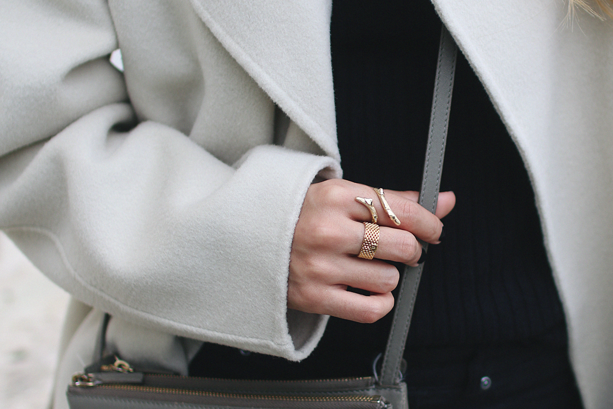 Desi is wearing a Sandro coat, Céline Trio bag, Gucci Princetown slippers and a all black look. - teetharejade.com