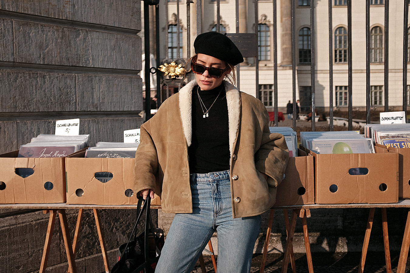 Desi is wearing: Céline Kate Sunglasses, Burberry Giant Shopper, Wool beret, Isabel Marant Éroile Shearling jacket, Mom jeans, Totême Turtleneck, Chelsea boots