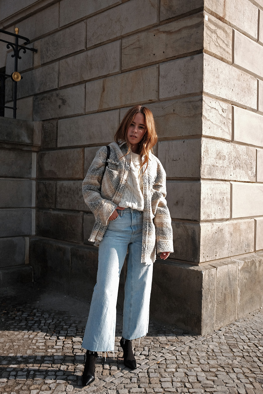 Outfit: Cable Knit and Cropped Flared Denim. Desi is wearing: Céline Madame Boots, Céline Eva sunglasses, Mansur Gavriel Elegant bag, Cropped flared denim jeans, checked wool-blend bouclé shirt, cable knit jumper