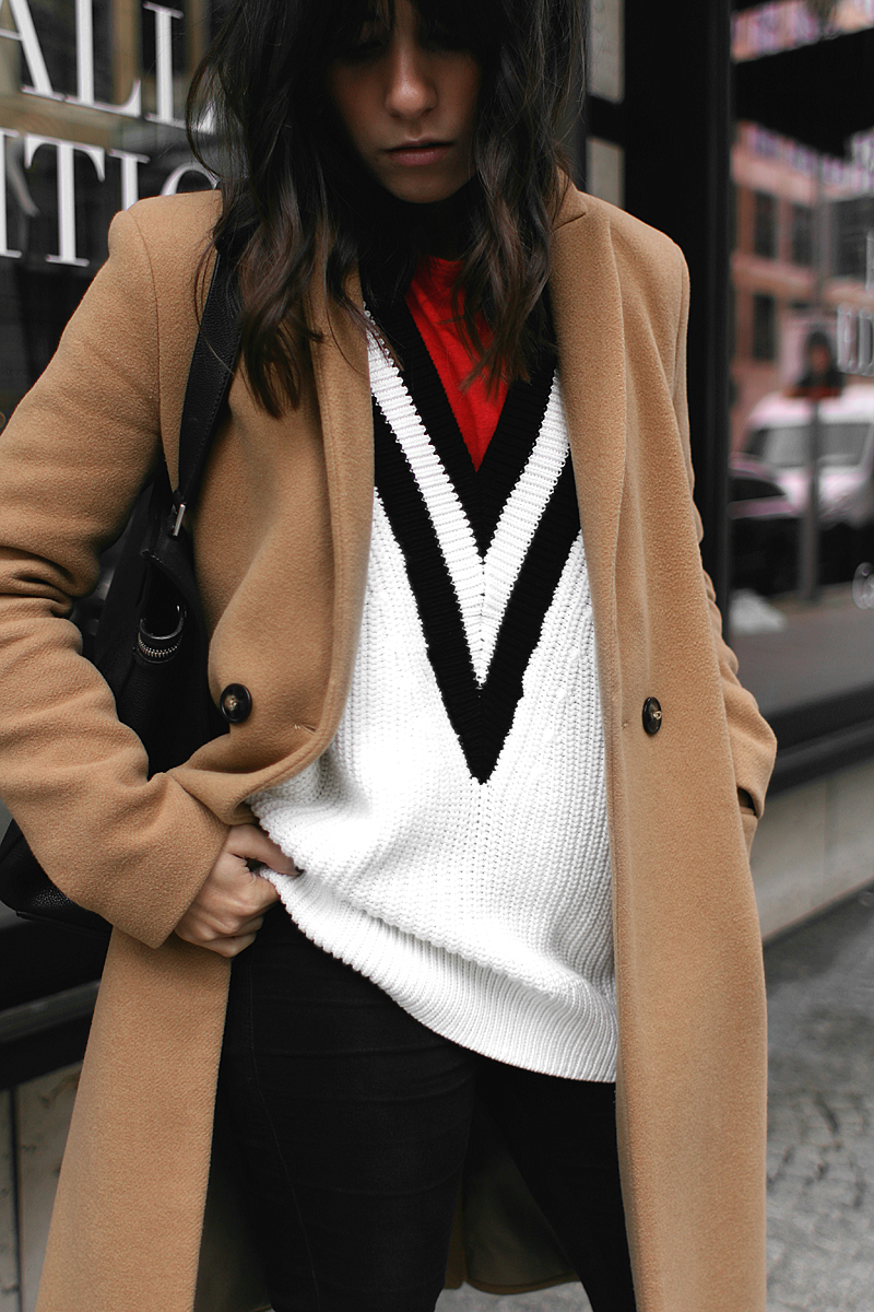 Nisi is wearing: Camel Coat, Céline Edge bag, skinny jeans, Jimmy Choo Tide sling-back pumps, V-neck knit