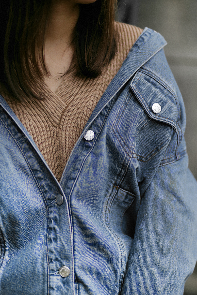 Nisi is wearing: Denim Jacket alla Balenciaga, Proenza Shoulder Hava bag, Python print boots, Cornelia Webb Earrings, Nude sweater, Black skinny jeans