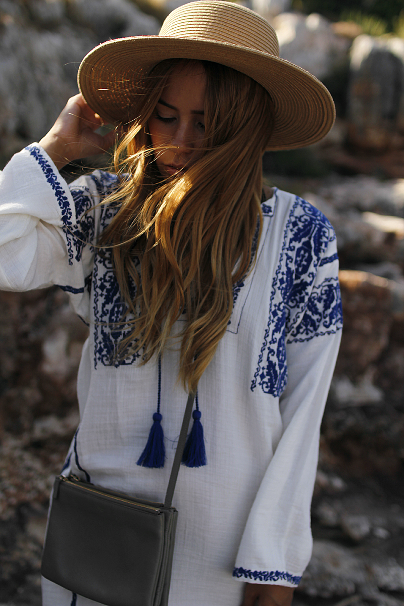 Outfit: Embroided Tunic in Cala Figuera. Desi is wearing a Céline trio bag, Arizona Brikenstock sandals, straw hat and Isabel Marant embroided tunic