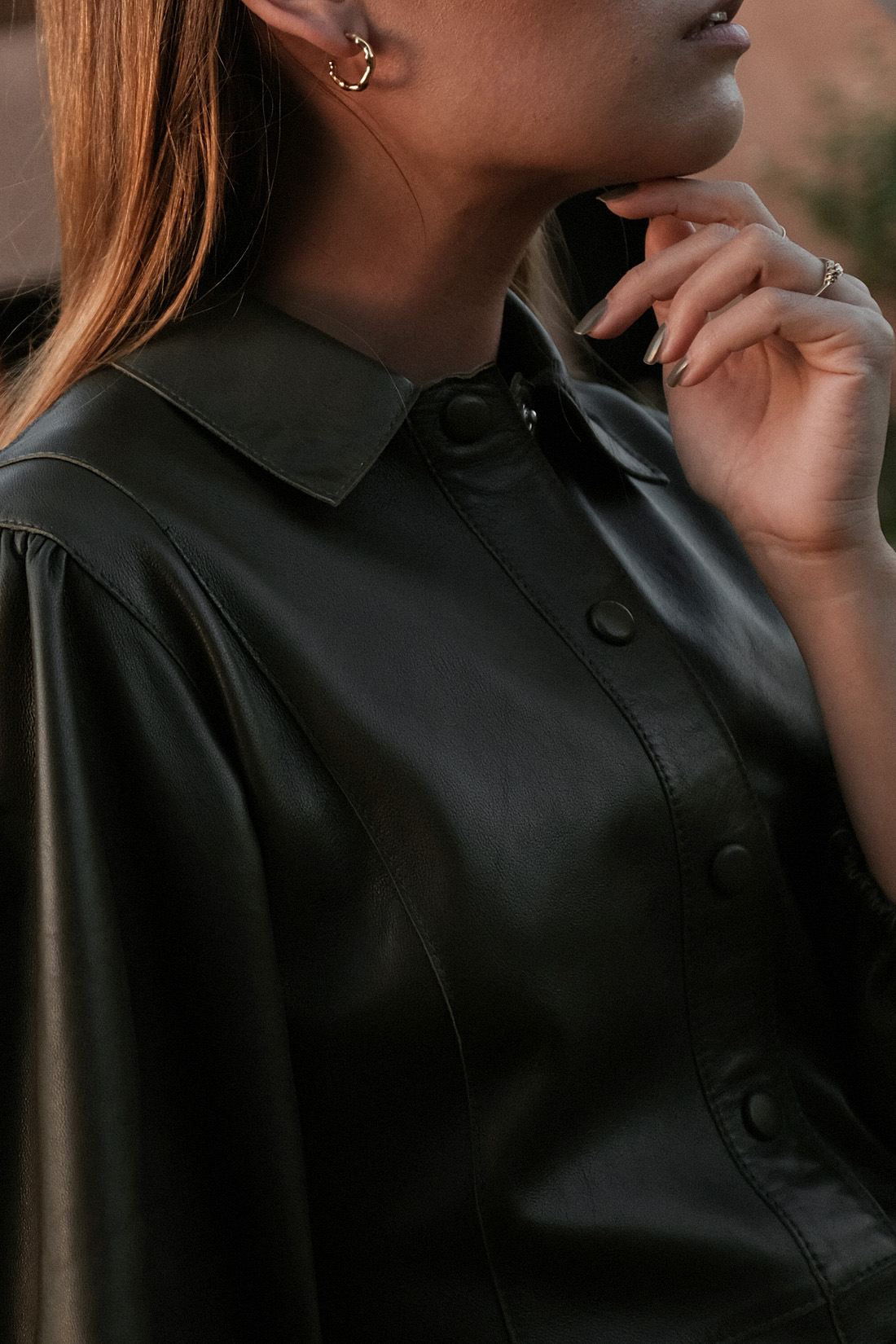 Desi is wearing: Ganni Leather minidress, Rejina Pyo Zeo Strappy leather mules, Saint Laurent New Wave 276 cat-eye sunglasses, Earrings L’Or Liquide