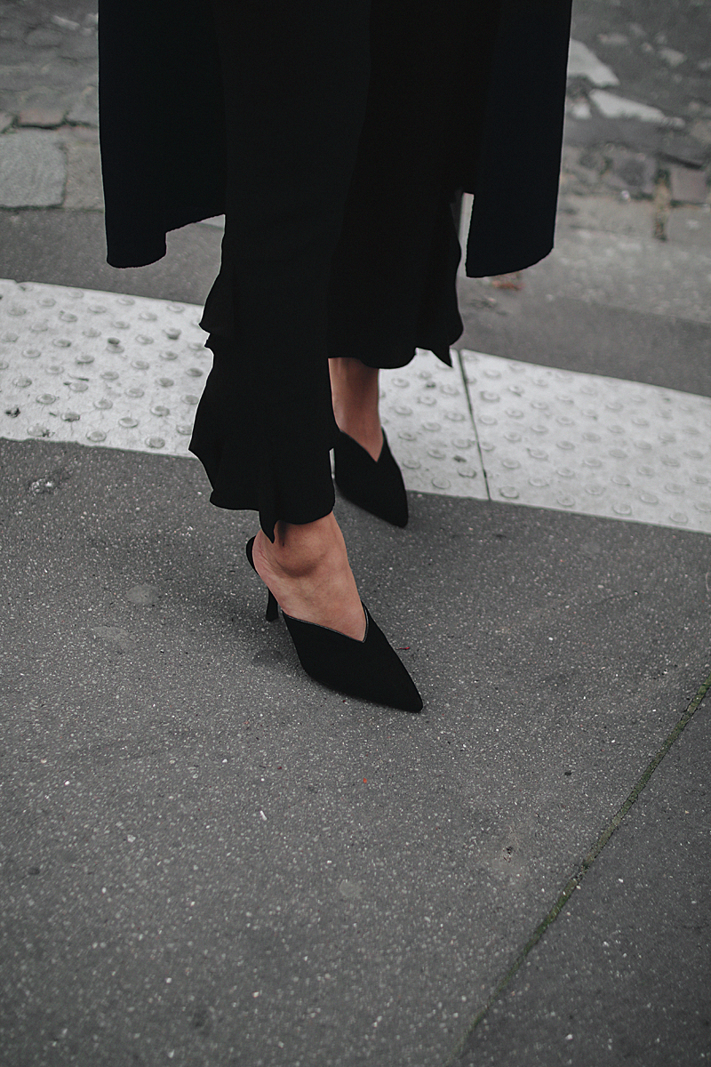 Outfit: With Frills and Mules in Paris. Desi is wearing Prada mules, Loewe bag, Thrasher shirt, Zara frill pants, H&M earrings