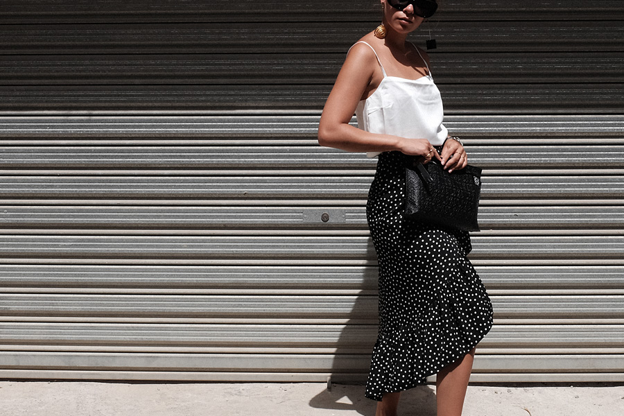 Desi is wearing: Jacquemus Le Carre spiral earrings, Loewe T Pouch, Celine Sunglasses, Vila Polka dot wrap skirt, Asos phyton sandals, Edited the Label Camisole