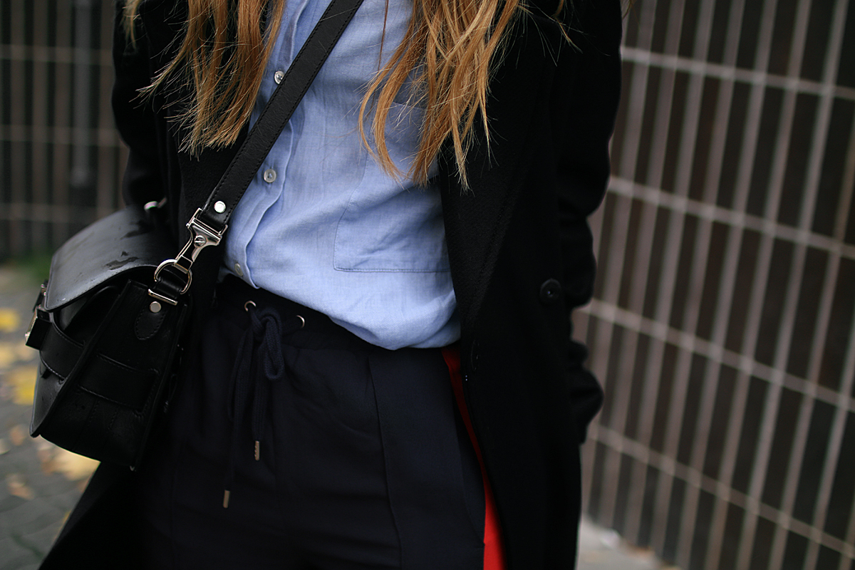 Desi is wearing: Proenza Schouler PS11 bag, side stripe pants, button down shirt, oversized coat and Adidas stan smith sneakers