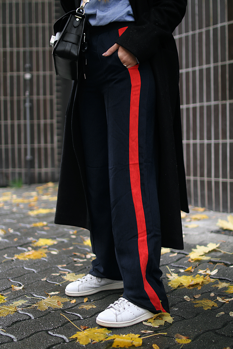 Desi is wearing: Proenza Schouler PS11 bag, side stripe pants, button down shirt, oversized coat and Adidas stan smith sneakers