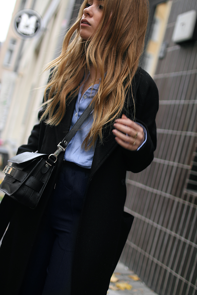 Desi is wearing: Proenza Schouler PS11 bag, side stripe pants, button down shirt, oversized coat and Adidas stan smith sneakers