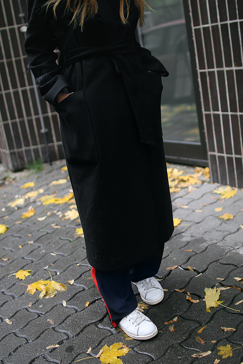 Desi is wearing: Proenza Schouler PS11 bag, side stripe pants, button down shirt, oversized coat and Adidas stan smith sneakers