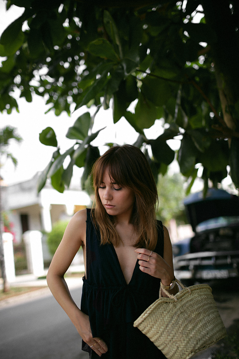 Nisi is wearing: See by Chloé top with ruffles, black denim mom jeans, ATP Atelier sandals, Straw bag, Rosefield gold mesh watch