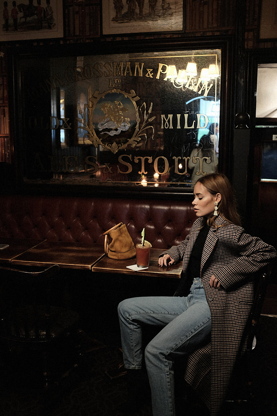 Desi is wearing: Checked coat, Mom jean, Simone Miller Bucket bag, Acetate Earrings