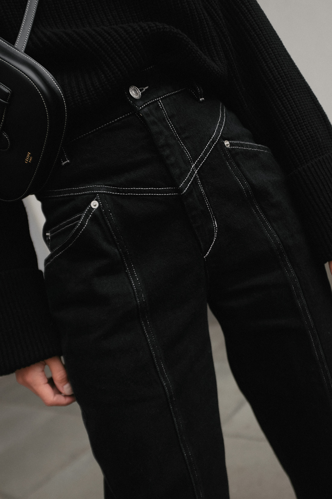 Nisi is wearing: Isabel Marant jeans, Céline Mini Symmetrical Bag, Céline Madame boots, Black turtleneck knit