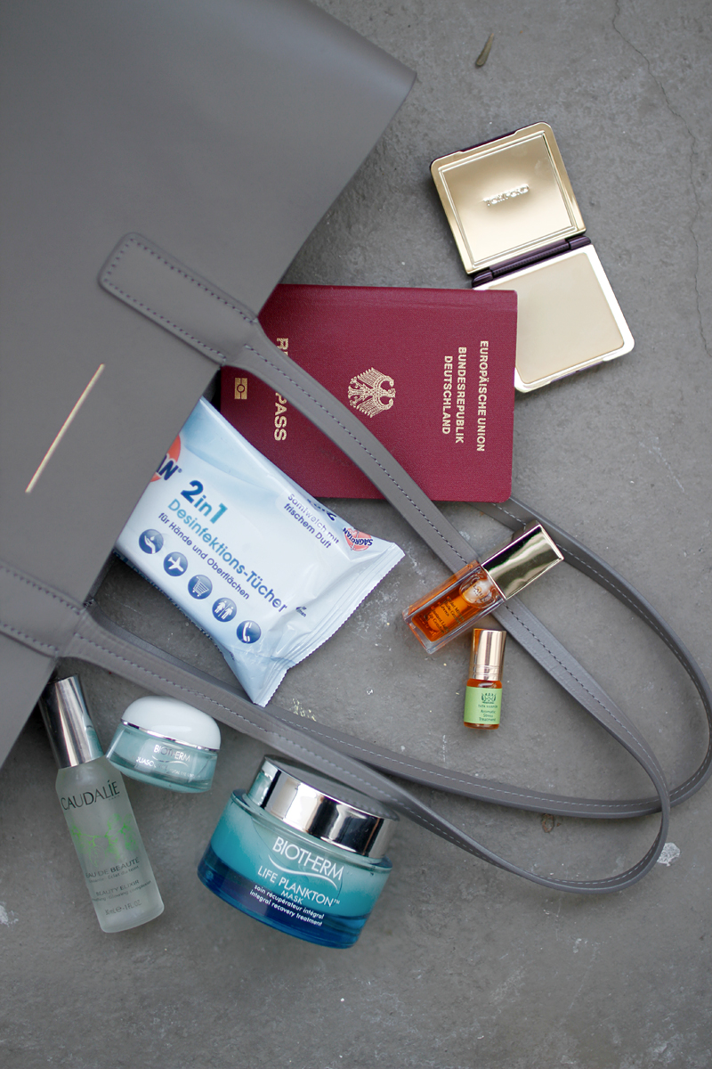 What's in my carry-on beauty bag: Caudalie Eau de Beauté, sanitizer tissues, Clarins Instand Light Lip Comfort Oil, Tata Harper Aromativ Stress Treatment, Biotherm Aquasource Total Eye Revitalizer, Biotherm Life Plankton Mask, Tom Ford Velvet Orchid Compact