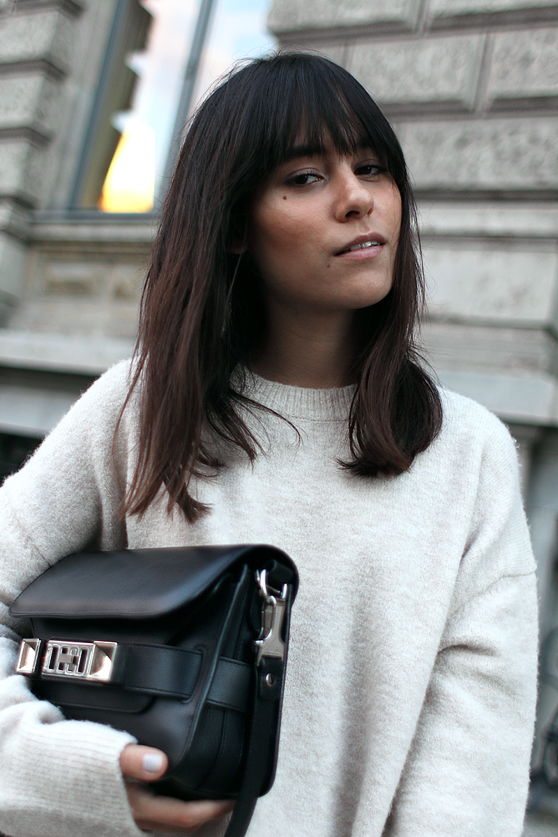 Outfit - Wide and comfy. Nisi is wearing: White wide-leg pants, oversized knit sweater, Proenza Schouler PS11 Mini Classic Bag, Hermès Oran sandals
