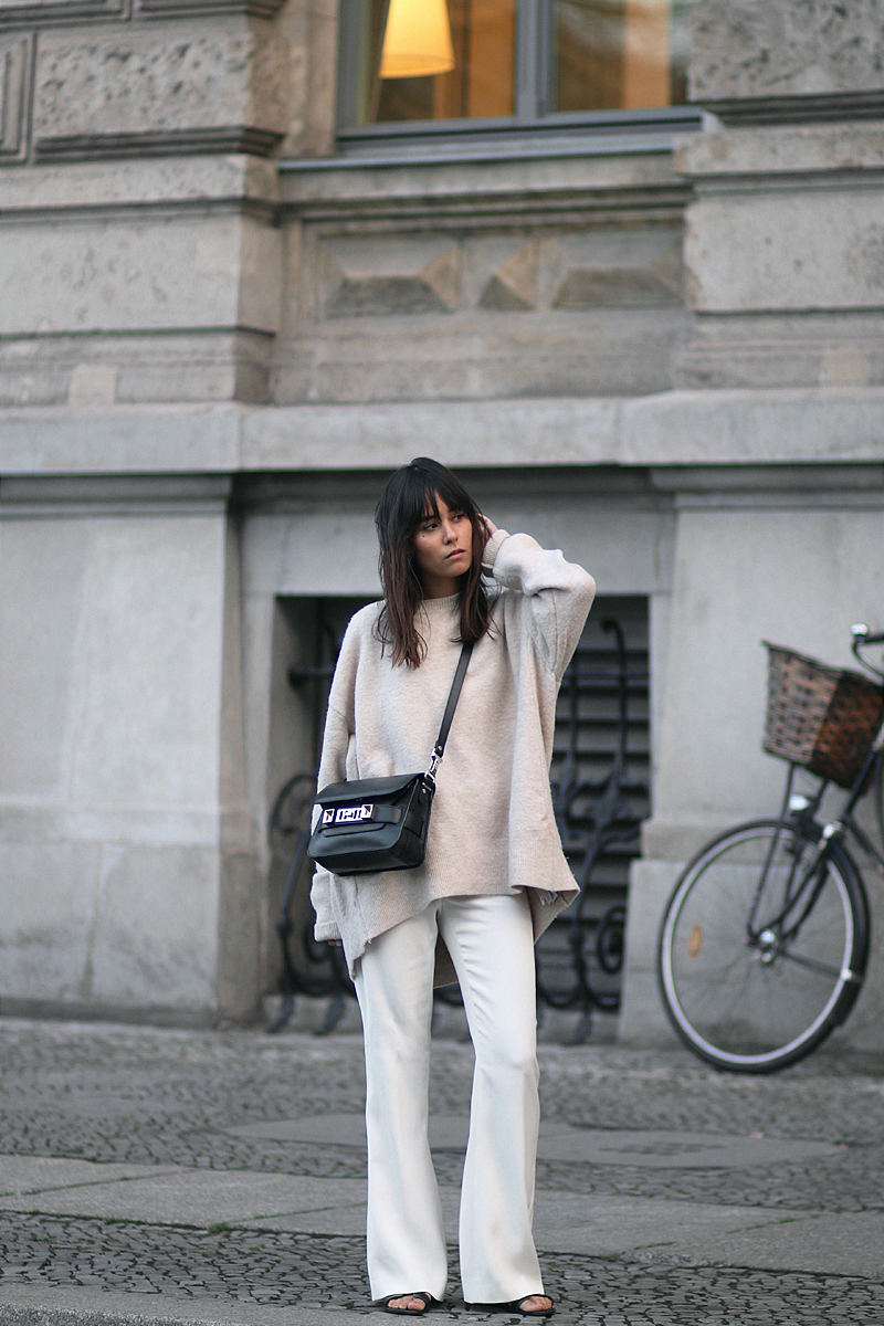 Outfit - Wide and comfy. Nisi is wearing: White wide-leg pants, oversized knit sweater, Proenza Schouler PS11 Mini Classic Bag, Hermès Oran sandals