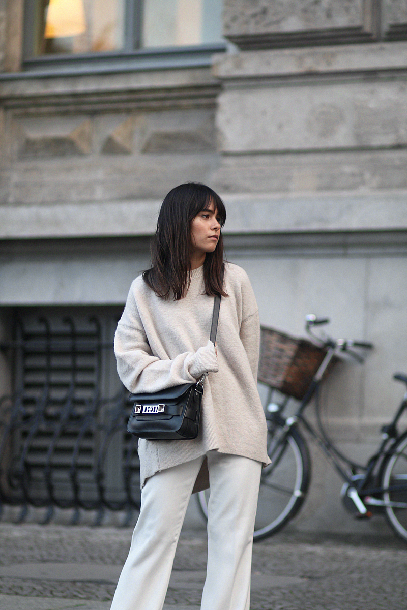 Outfit - Wide and comfy. Nisi is wearing: White wide-leg pants, oversized knit sweater, Proenza Schouler PS11 Mini Classic Bag, Hermès Oran sandals