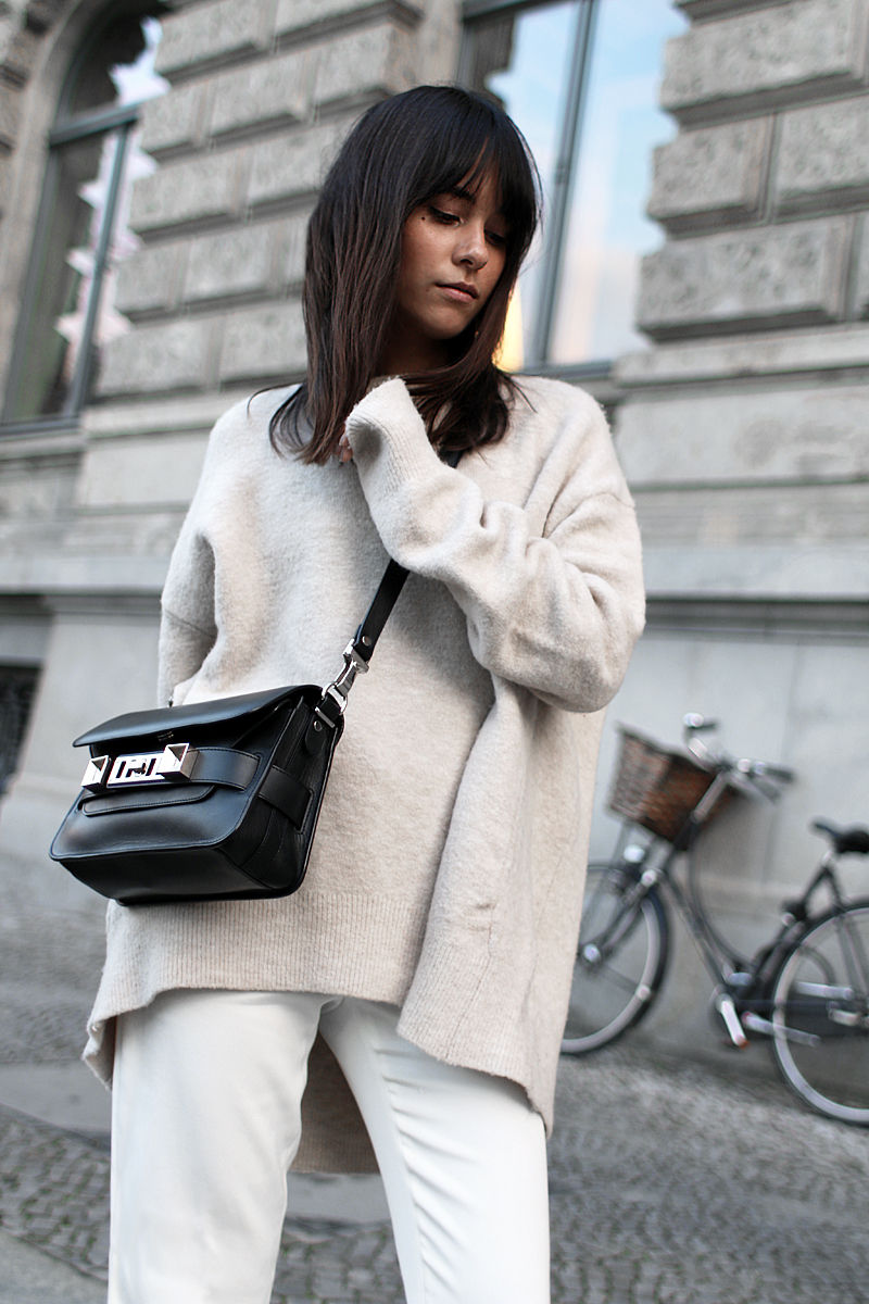Outfit - Wide and comfy. Nisi is wearing: White wide-leg pants, oversized knit sweater, Proenza Schouler PS11 Mini Classic Bag, Hermès Oran sandals