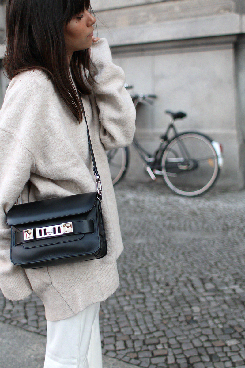 Outfit - Wide and comfy. Nisi is wearing: White wide-leg pants, oversized knit sweater, Proenza Schouler PS11 Mini Classic Bag, Hermès Oran sandals