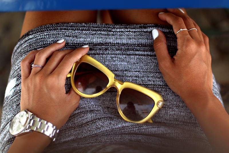Nisi is wearing a knitted two piece from American Apparel, blue Givenchy Obsedia bag and yellow sunglasses from Komono